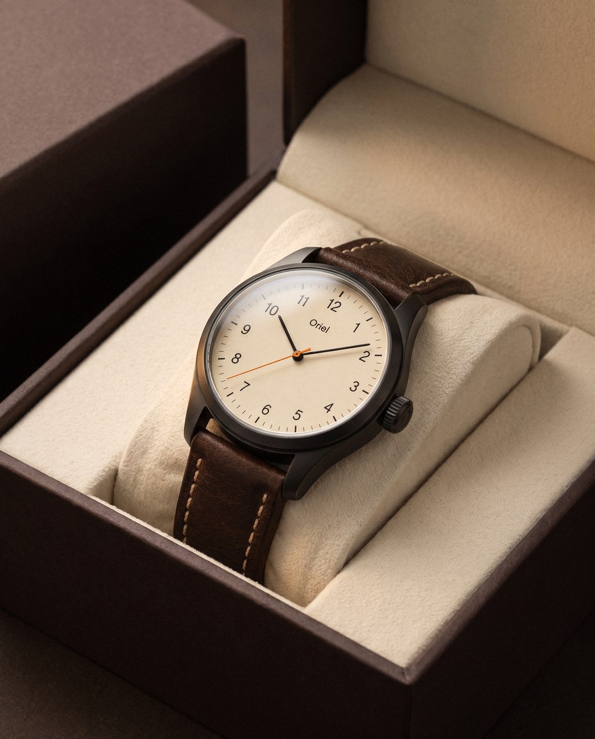 The watch in its open box, wrapped around a cream cushion.