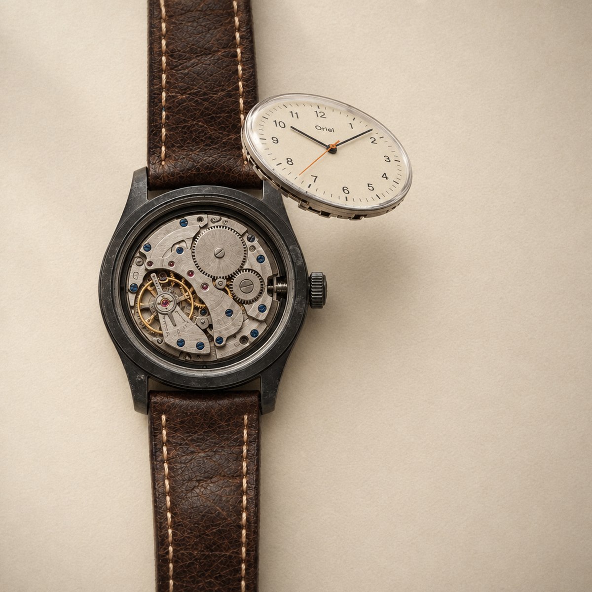 The cream dial lifted clear of the case, with the movement showing inside.